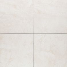 a white tile wall with four squares in it