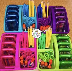 several trays filled with different colored pencils and markers