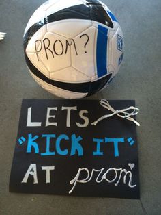 a soccer ball sitting on the ground next to a sign that reads, prom? lets kick it at prom