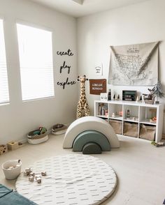 a child's room with giraffes and toys on the floor