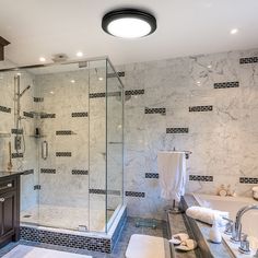 a large bathroom with marble walls and flooring