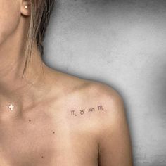 a woman's chest with the word mom tattooed on her left shoulder and an arrow in the middle