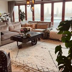 a living room filled with furniture and lots of windows