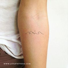 a woman's arm with a tattoo on it that has the word mom written in cursive font