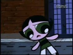 the powerpuff character is walking down the street in front of a brick building