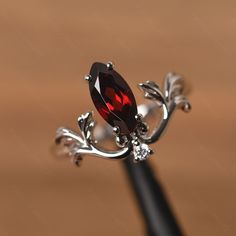 It is a garnet ring. The main stone is 5 mm* 10 mm marquise cut. weight about 1.35 carats. The basic metal is sterling silver and plated with rhodium. To change the metal to a solid gold (white/rose) or platinum is also available, please ask for a quotation if you want. You can also go to my shop Home for more elegant rings: https://www.etsy.com/shop/godjewelry?ref=hdr_shop_menu Alexandrite is June birthstone More alexandrite rings: https://www.etsy.com/shop/godjewelry?ref=seller-platform-mcnav& Silver Romantic Rings, Garnet Engagement Ring Silver, Ruby Engagement Ring Silver, Ruby Ring Silver, Alexandrite Rings, Nontraditional Engagement Rings, Gothic Wedding Rings, Elegant Rings, Garnet Ring Silver