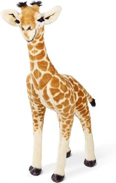 a stuffed giraffe is standing in front of a white background and it's head turned to the side