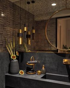 a bathroom with a sink, mirror and vase on the counter in front of it