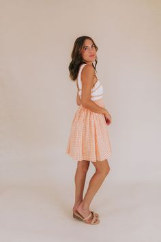 Get your style game on point with our Orange You Glad Dress! This mini dress features a unique combination of an off white embroidered bodice and a bright coral orange gingham skirt. With orange scalloped details and functional pockets, this dress is perfect for a fun, sunny day out. And don't forget the square neckline and sleeveless design for a touch of effortless chicness. Stay trendy, stay comfortable! Details Off white embroidered bodice Bright coral orange gingham skirt Orange scalloped d Orange Mini Length Summer Dress, Summer Orange Mini Dress, Summer Mini Length Orange Dress, Orange Mini Summer Dress, Orange Mini Sundress For Brunch, Orange Summer Dress For Picnic, Orange Summer Picnic Dress, Orange Mini Length Summer Sundress, Cute Orange Dress For Day Out