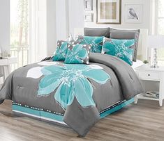 a bed with blue and gray flowers on it