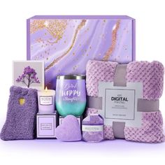 a purple gift box with candles, soaps and other items