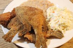 fried fish, mashed potatoes and cole slaw on a white plate