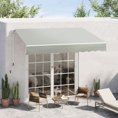 an awning on the outside of a house with patio furniture and potted plants