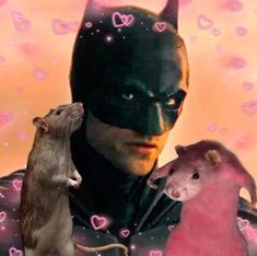 a rat and a mouse in front of a man wearing a batman costume with hearts on the background