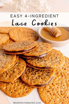 a pile of crackers sitting on top of a table next to a bowl of honey