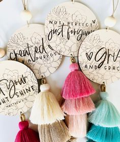 some tassels are hanging on a wall with the words, great friends and love