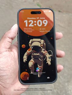 someone is holding up their phone with an image of an astronaut on it