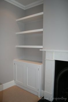 a white book shelf sitting next to a fireplace