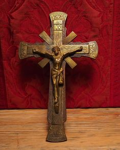 the crucifix is on display in front of a red wall