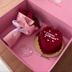 a pink box with a heart shaped cake in it next to a red rose that says i love you