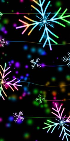 colorful snowflakes are flying in the air on a black background with multicolored lights