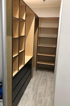 an empty walk in closet with shelves and drawers