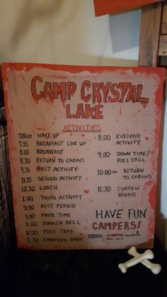 a sign advertising camp crystal lake activities in front of a wall with bones on it