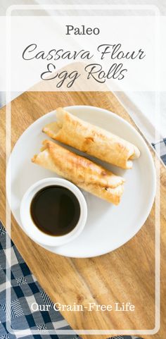 an egg roll on a plate with dipping sauce next to it and a cup of coffee