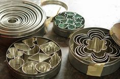 several metal tins with flower designs on them