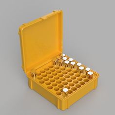 an open yellow case filled with lots of small white cups on top of each other