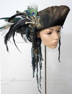 + + + Pirate Hat + + + The pirate hat is made of aged premium woolfelt. It is adorned with bones, various feathers, chains, buttons and textile materials. The hat is available in sizes between: 54 & 64 Size -> Circumference of your head in cm + + +     + + + Information about the feathers: Feathers are not colourfast and if they get wet it is possible that they change colour a little. Please note this if you come into heavy rain. + + +     + + + I create these hats in the studio "Maskenzauber & Authentic Pirate Hat, Big Pirate Hat, Pirate Hat With Feathers, Brown Pirate Hat, Diy Captain Hook Hat, Pirate Hats Diy, Decorated Pirate Hat, Pirate Hat Design, Pirate Hat Aesthetic