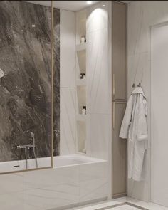 a white bath tub sitting next to a walk in shower