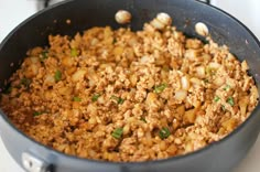 a pan filled with food sitting on top of a stove