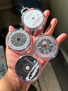 a person holding three different types of cds in their hand, with the same disc on each side