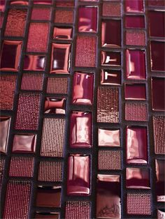 a close up view of some red glass tiles