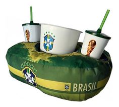 three cups sitting on top of a bean bag chair with the brazil national team logos