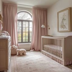 a baby's room with a crib, window and teddy bear in it