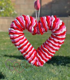 a red, white and pink heart hanging from a string