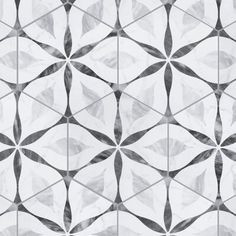 a white and black tiled wall with geometric designs