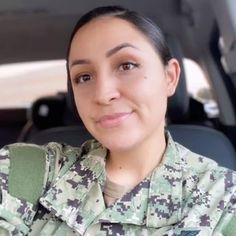 a woman in uniform is smiling for the camera