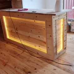 a wooden counter sitting on top of a hard wood floor