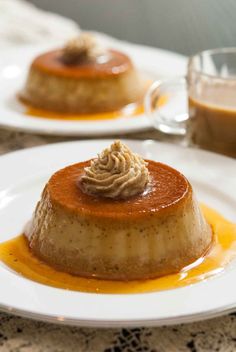 two white plates topped with desserts on top of a table next to each other