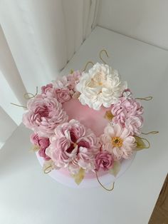 a cake with flowers on it sitting on a table