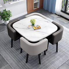 a dining room table with two chairs and a white marble top