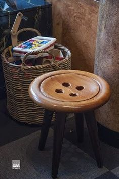 a small wooden stool sitting next to a basket