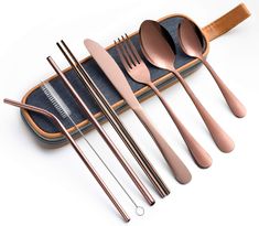 five spoons, two forks and one knife in a case with denim lining on the bottom