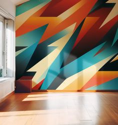 an abstract painting on the wall in a room with wood flooring and large windows