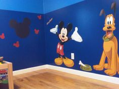 a child's room with mickey mouse and pluto wall decals