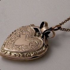 an antique heart shaped locke is shown on a chain