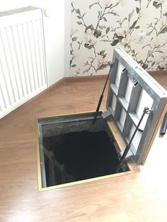 an open hole in the floor that is filled with water